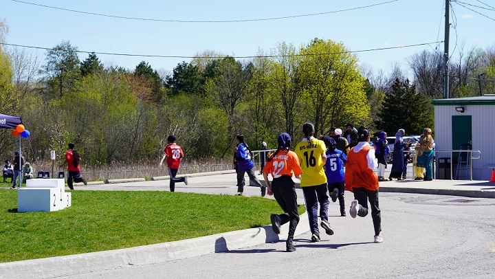 Students running a race on the school grounds during a track and field day